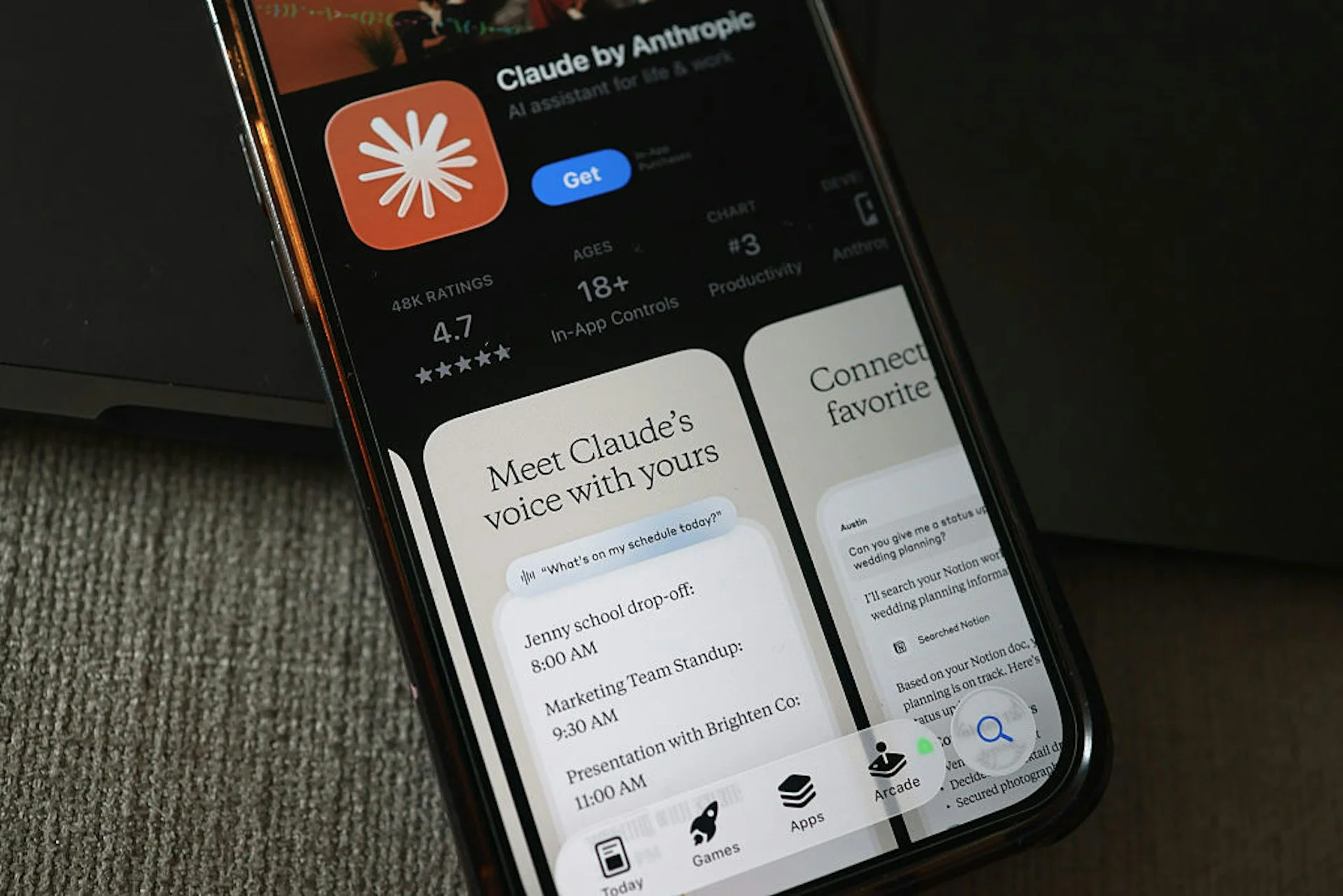 The Claude AI app is seen in the app store on a smartphone with the promotional text 'Meet Claude's voice with yours.'