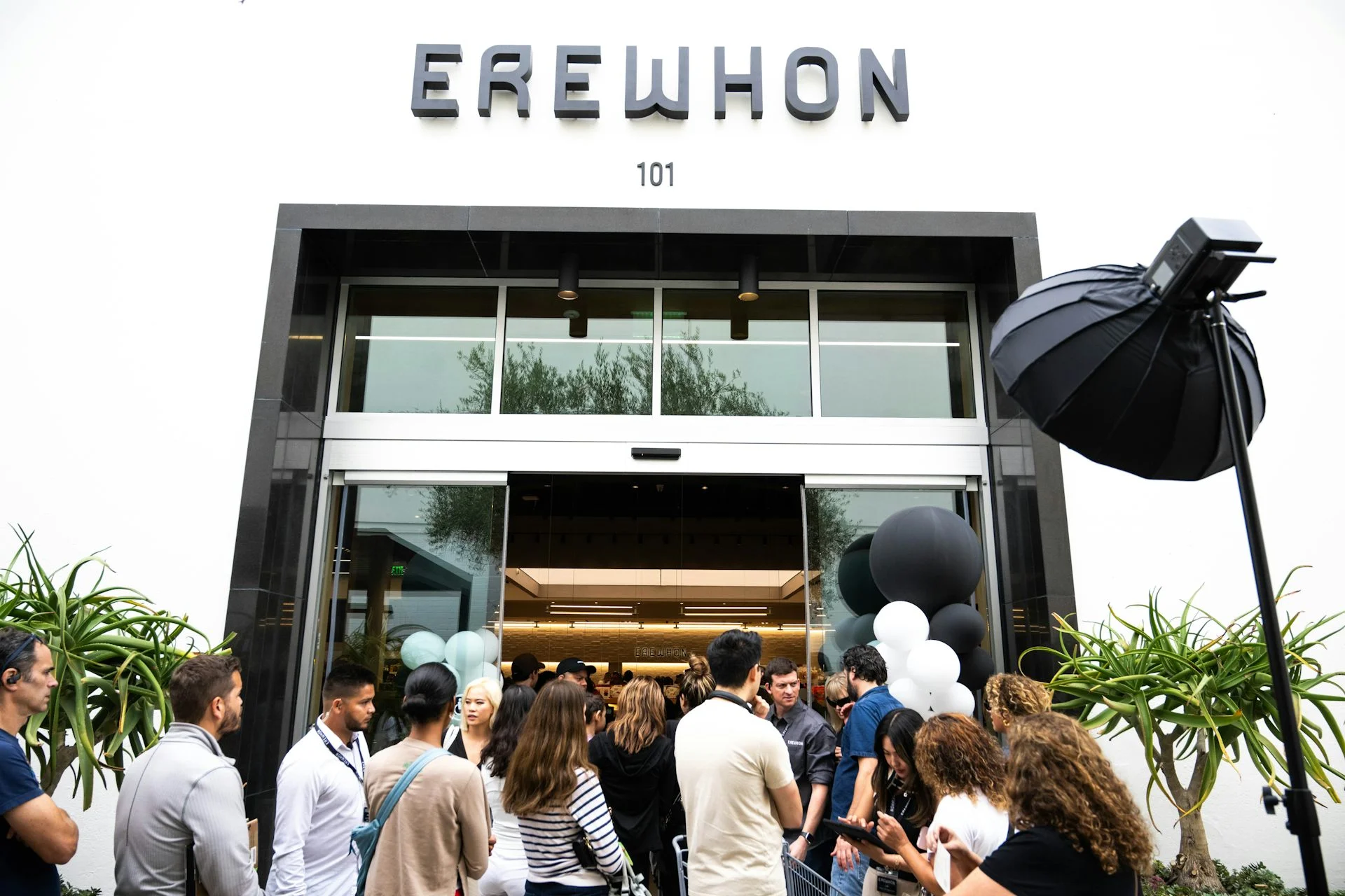 Shoppers enter and exit the crowded high-end grocery store Erewhon in Pasadena, Calif.