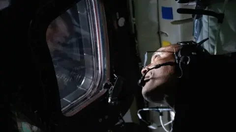 NASA  Victor Glover looks out of the window of the Orion spacecraft 
