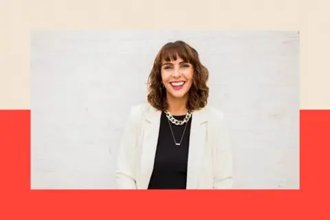 Vicki Pavitt A shot of Vicki Pavitt wearing a white suit with a black top.